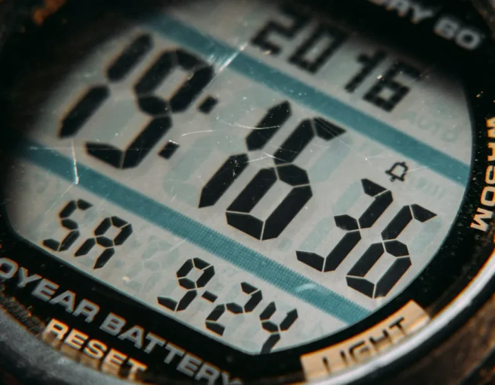 Macro detail of a digital watch display showing the time and date