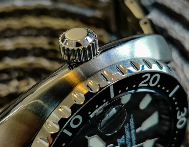 Macro detail of a dive watch bezel and steel case