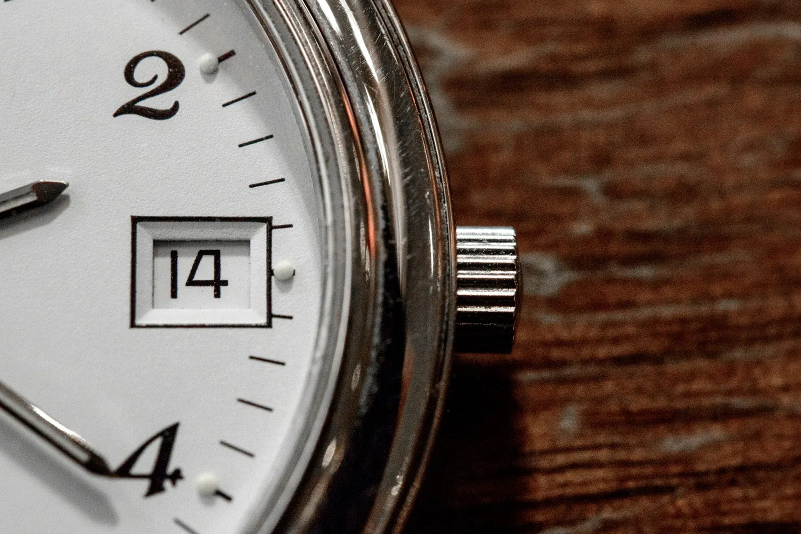 Extreme close-up of a watch dial showing printed minute markers
