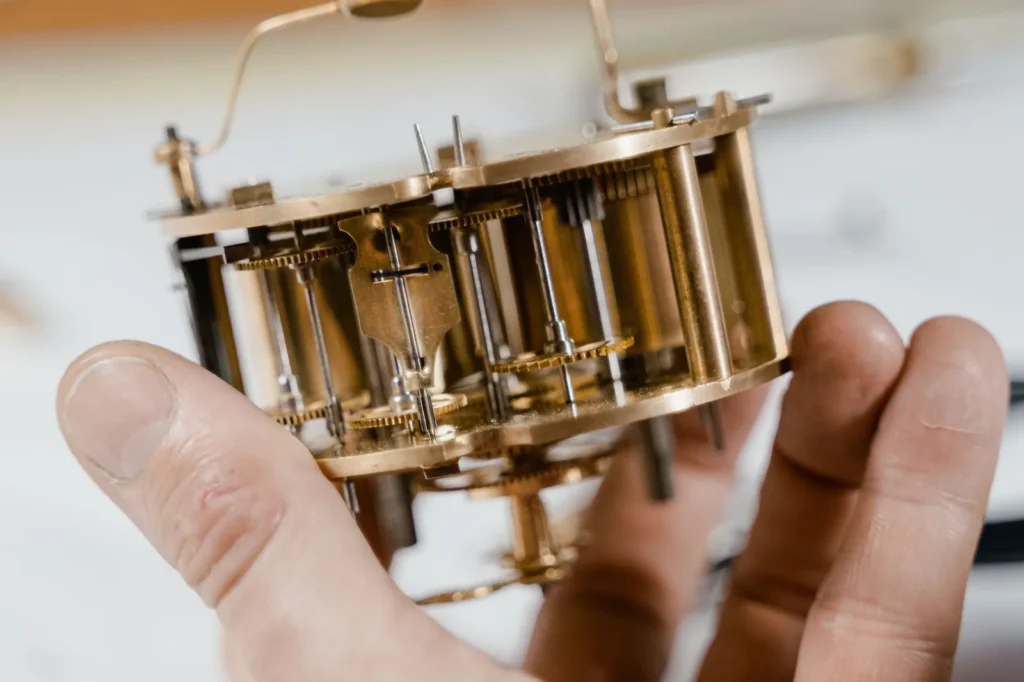 A brass movement held in the hand, seen close up