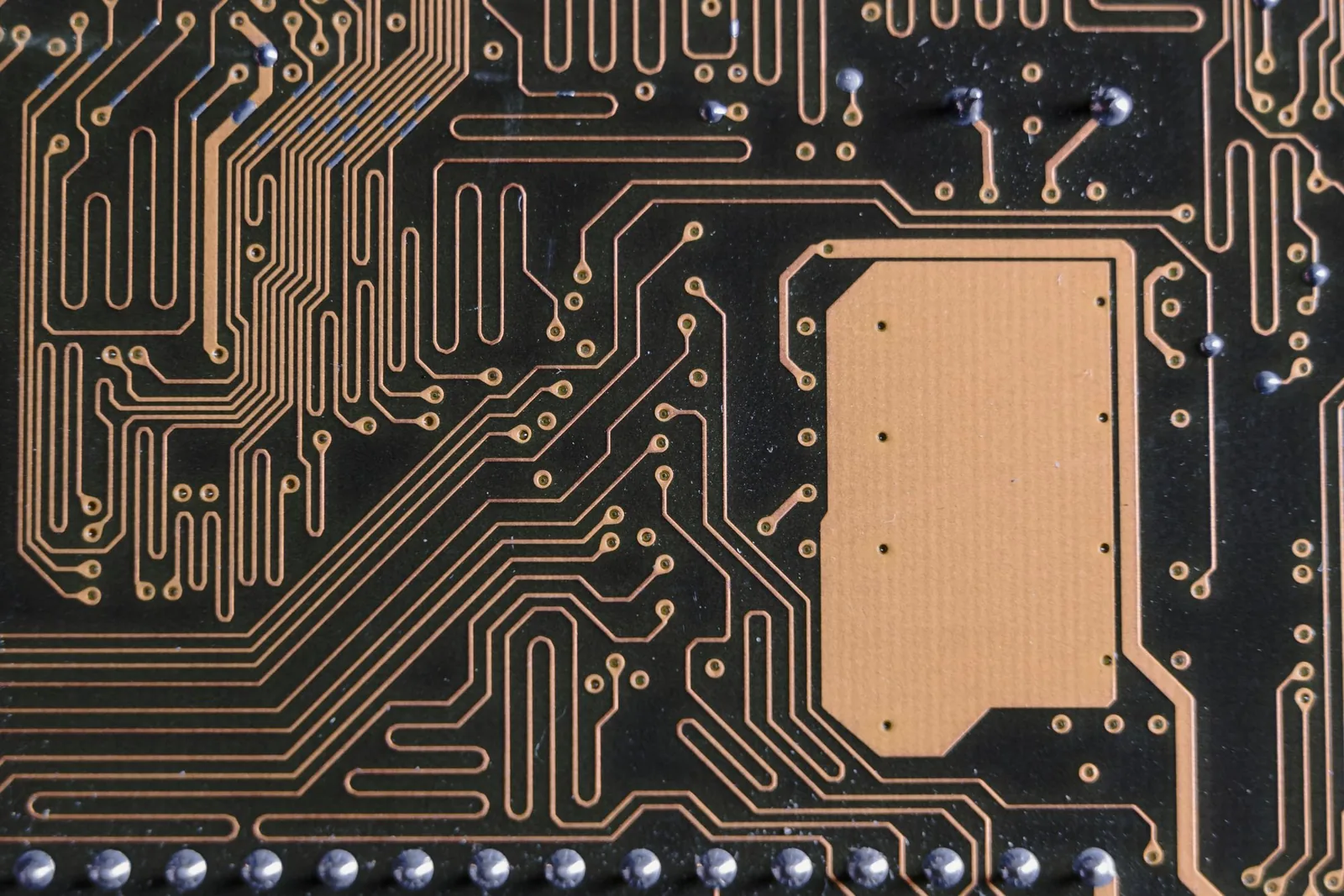 The fine traces of a circuit board seen at high magnification