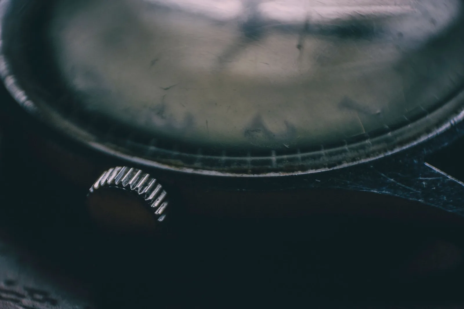 The crown and winding stem of a watch photographed close up
