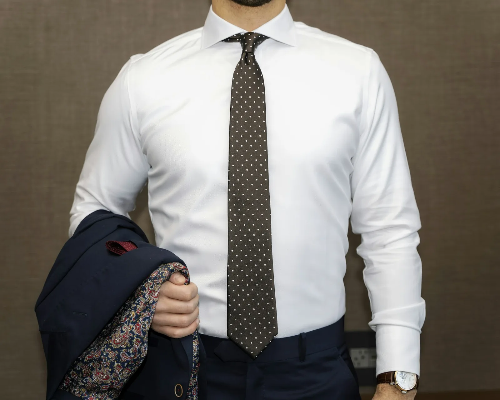 A shirt cuff resting against a wrist in soft light