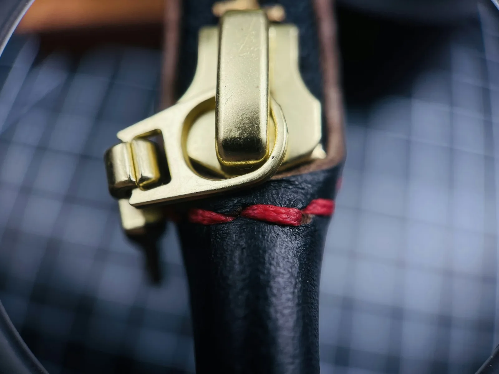 The buckle of a leather strap photographed close up