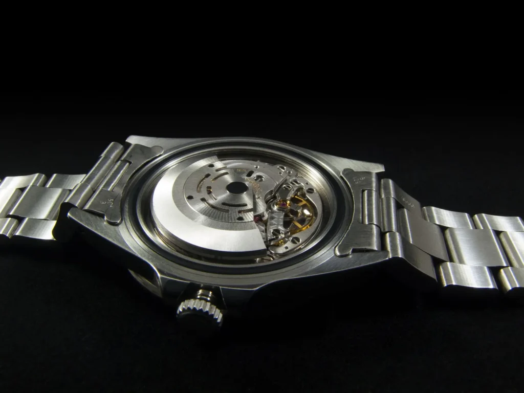 The oscillating weight of an automatic movement seen through a transparent case back