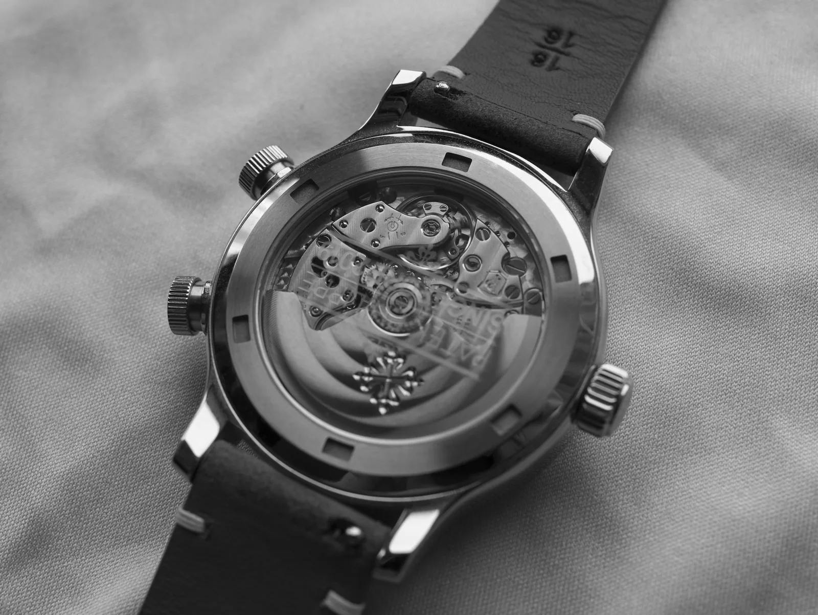 A watch movement seen through a transparent case back