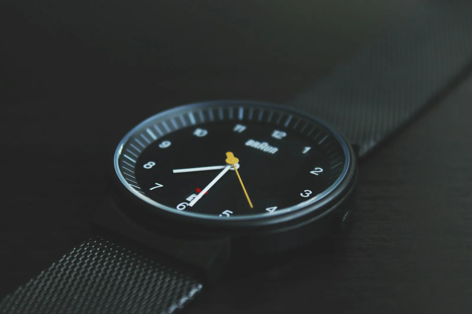 The printed minute track of a watch dial seen close up