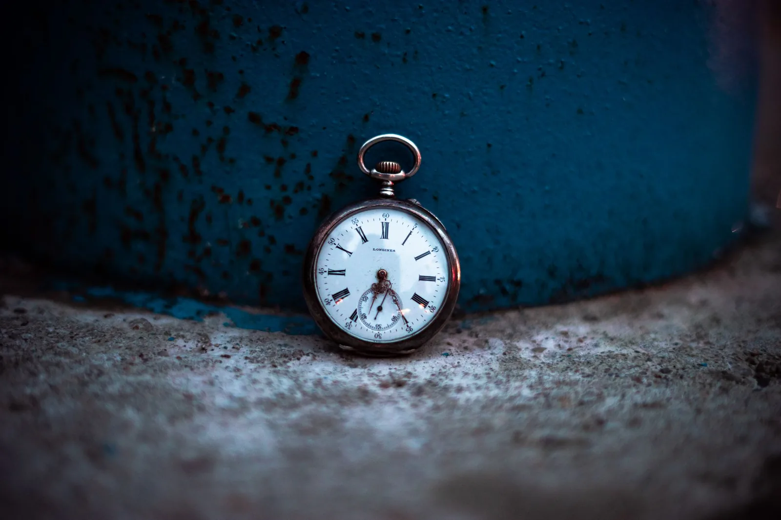 A pocket watch resting in low light