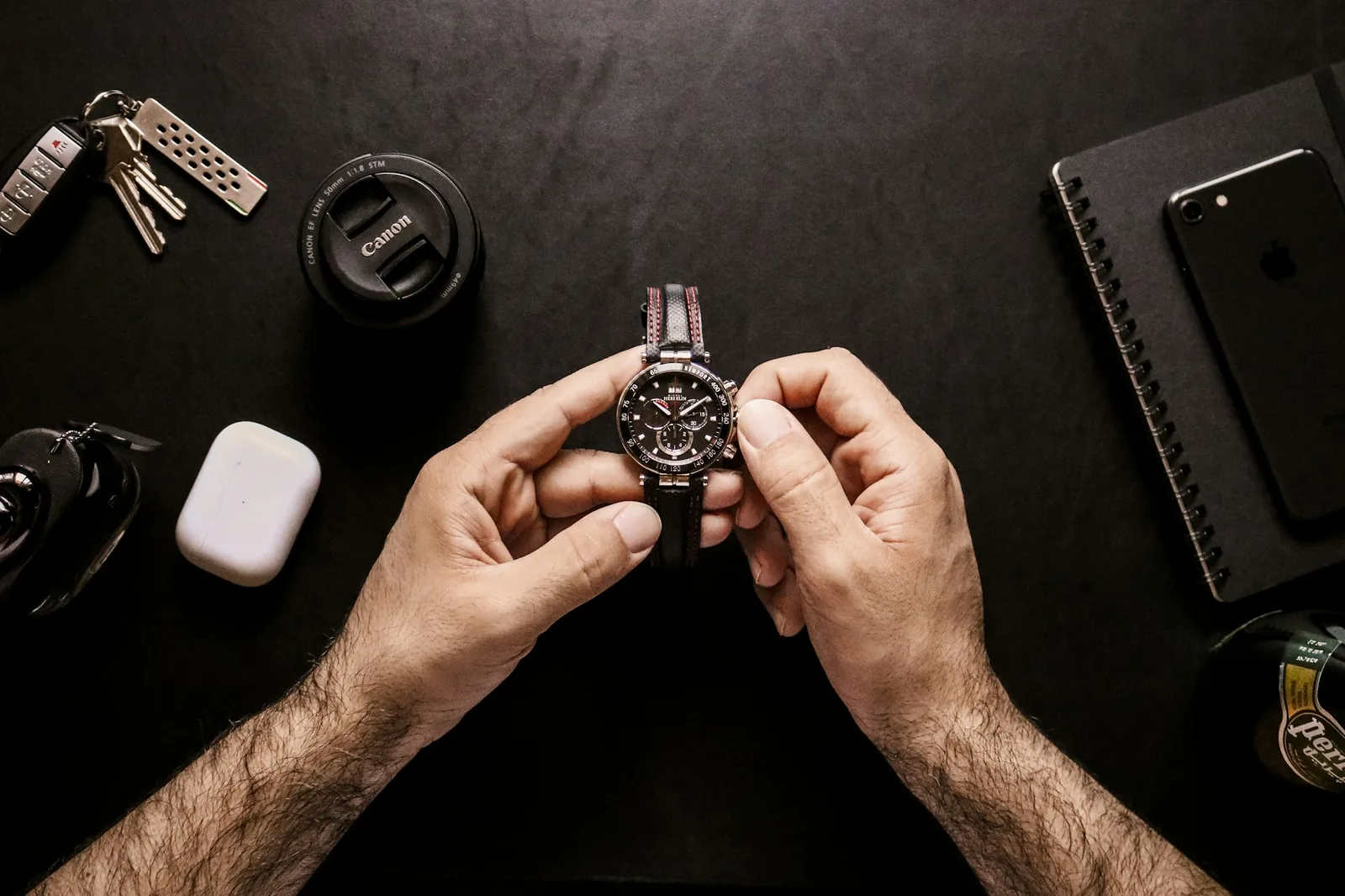 Several wristwatches of different styles arranged on a plain surface and seen from above