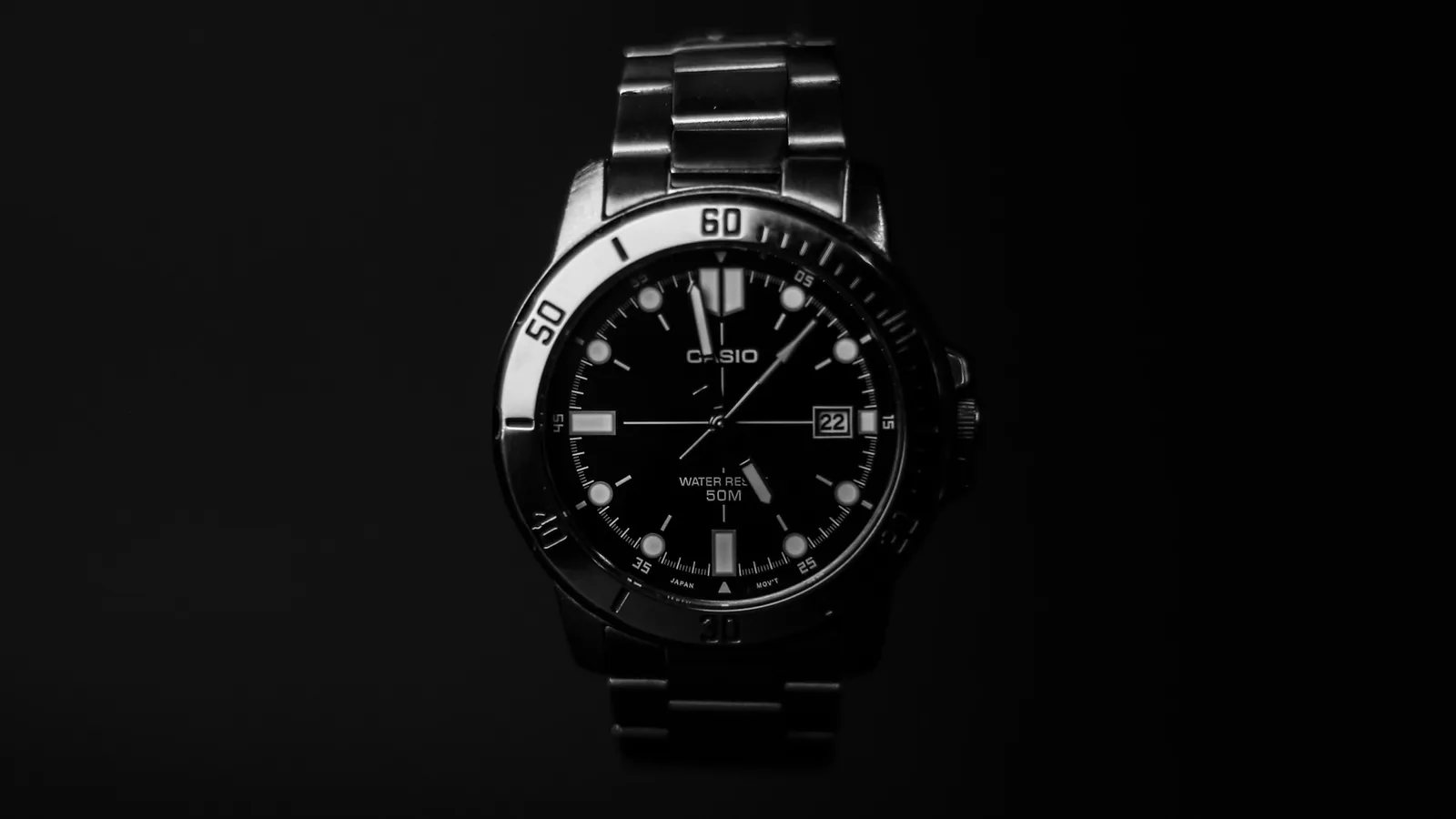 A dive watch seen from directly above, showing the minute markings on the rotating bezel
