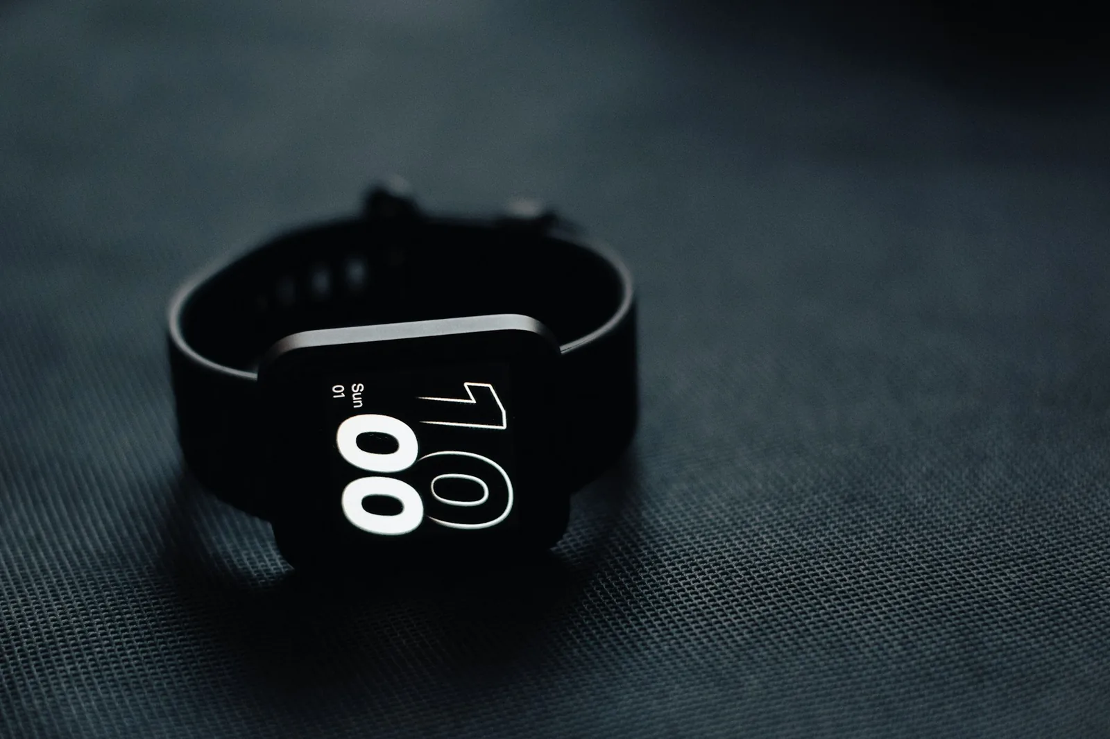 A digital watch photographed close up, showing its display and side buttons