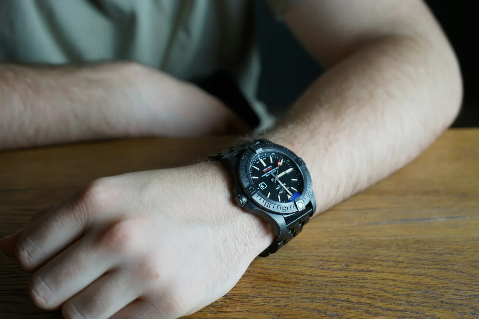 Two people handling a wristwatch across a table
