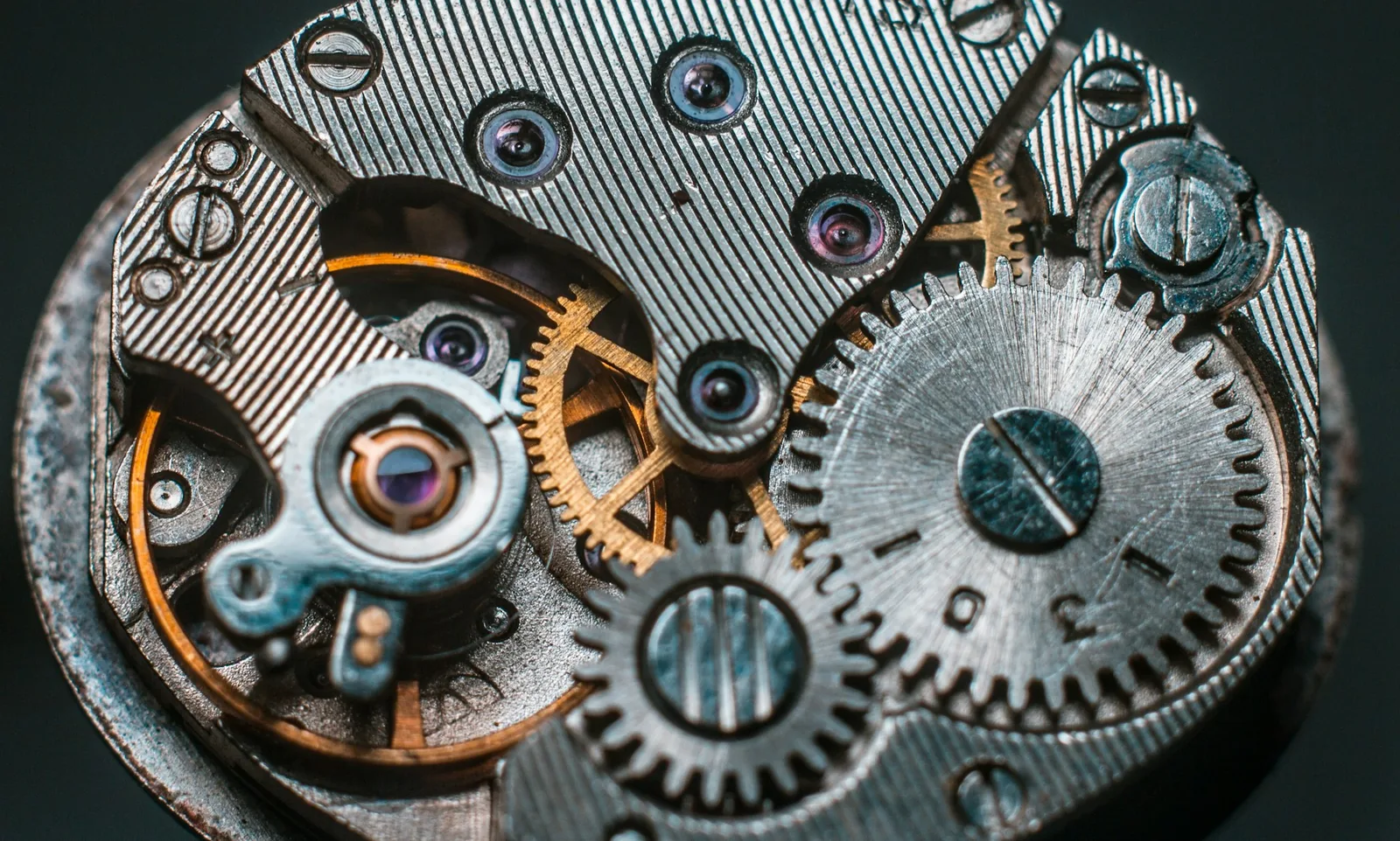 Interlocking brass gear wheels in a clock mechanism seen close up