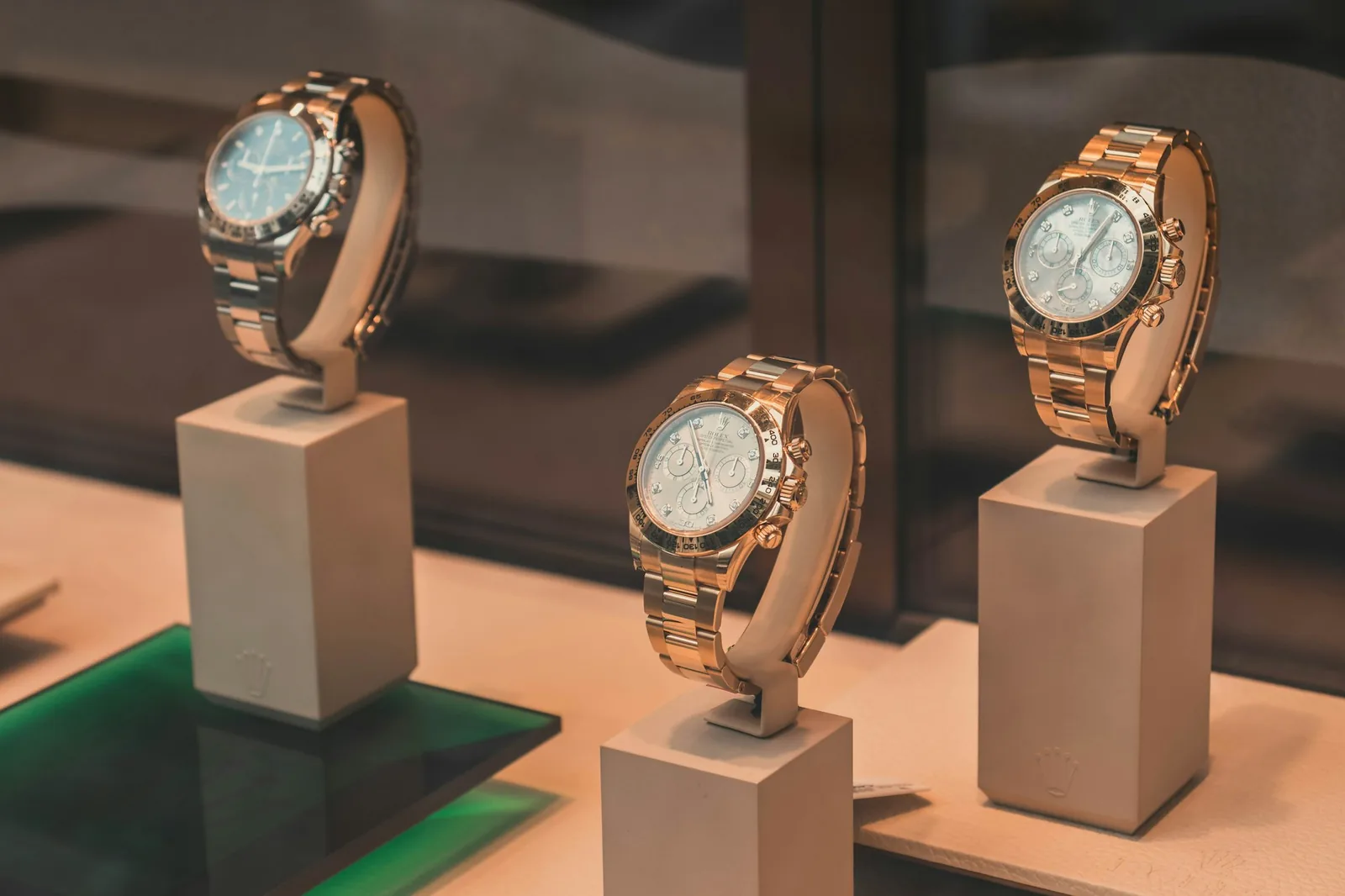 Wristwatches displayed under glass in a lit retail cabinet