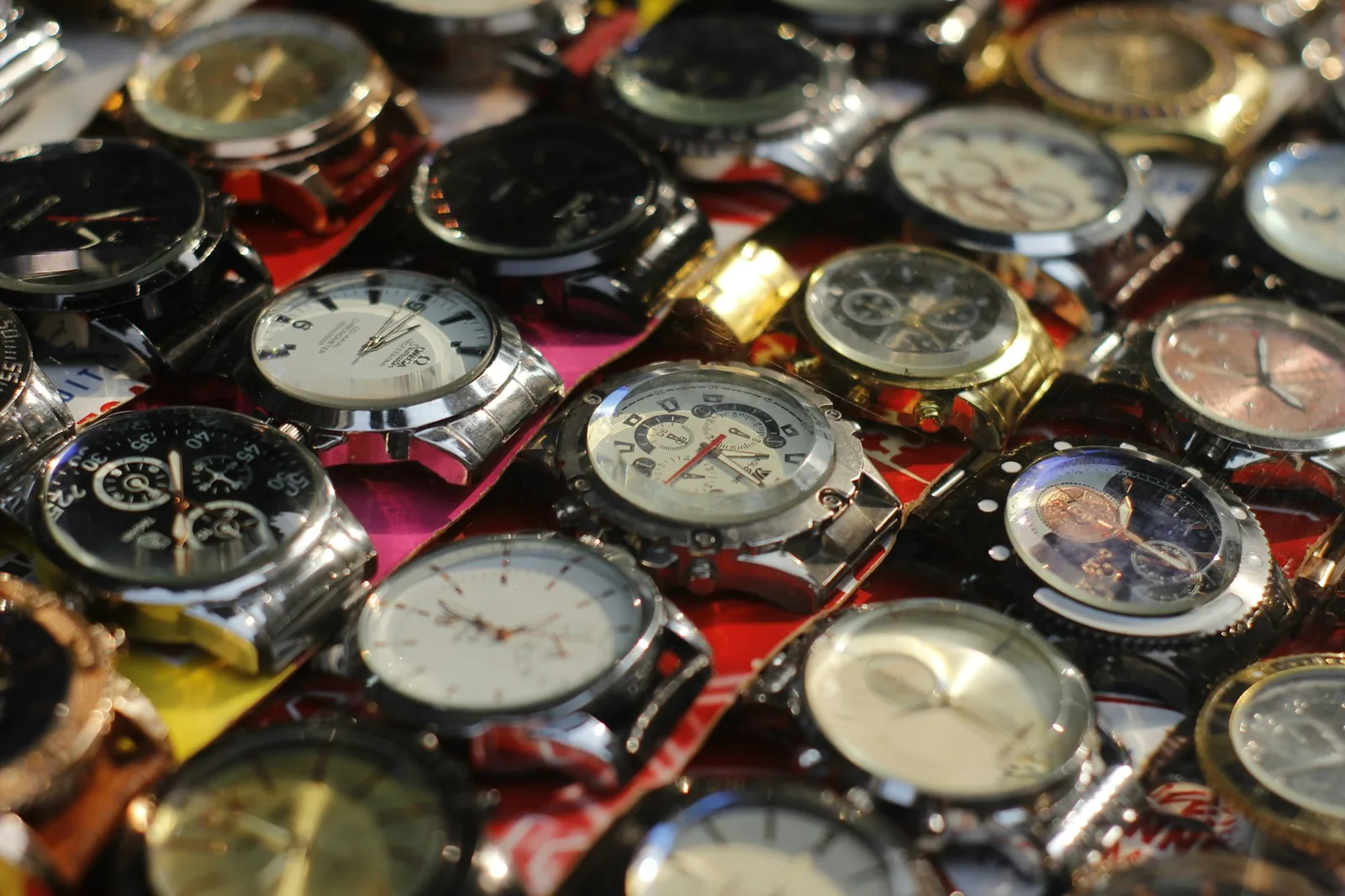 Several wristwatches arranged in the compartments of a lined watch case