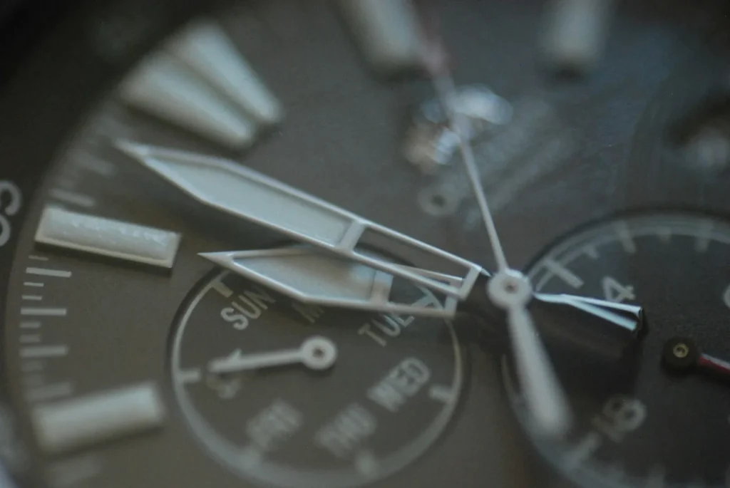 A chronograph dial photographed close up, showing two subdials and a date window