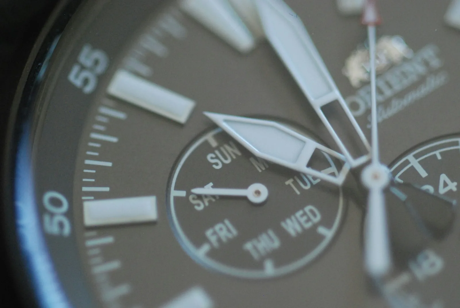 A chronograph dial photographed close up, showing two subdials and a date window