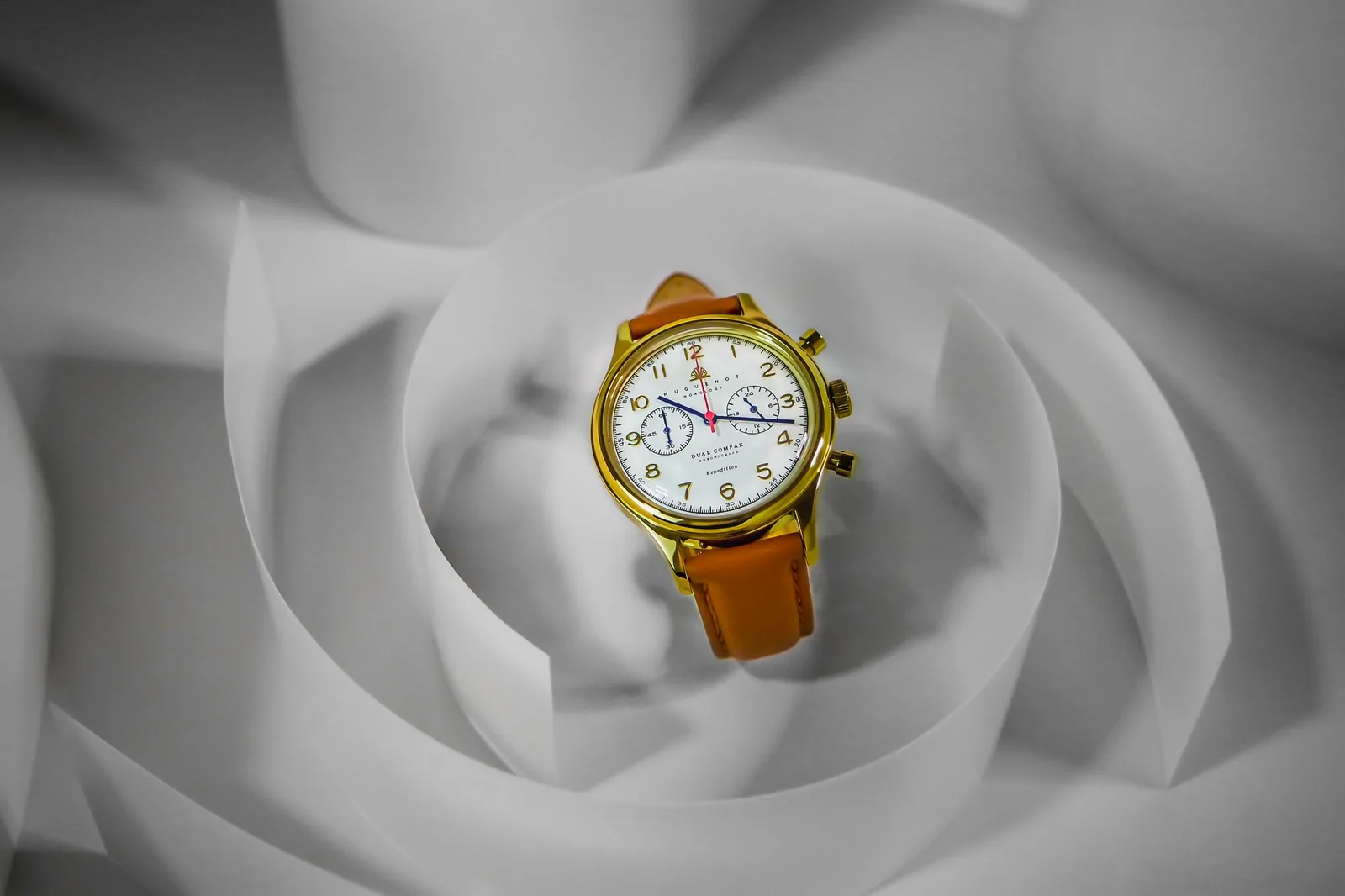 The side of a chronograph case showing the crown between two pushers