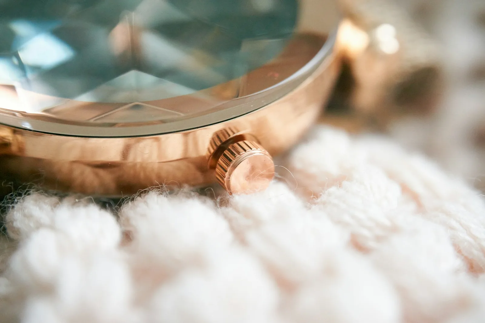 The edge of a gold-coloured watch case where the plating has worn through