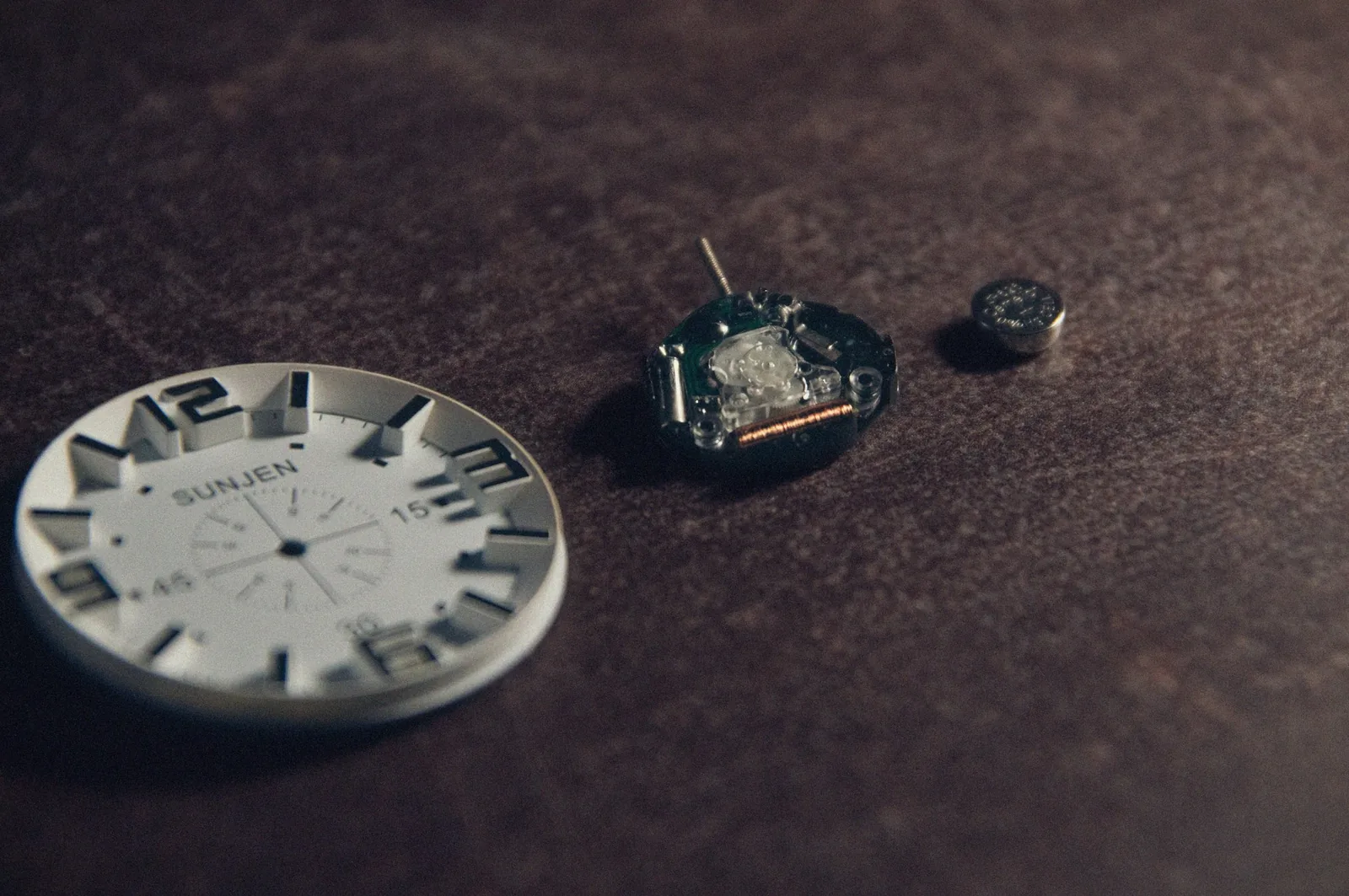 The circuit board and battery of a quartz watch movement seen with the case back removed