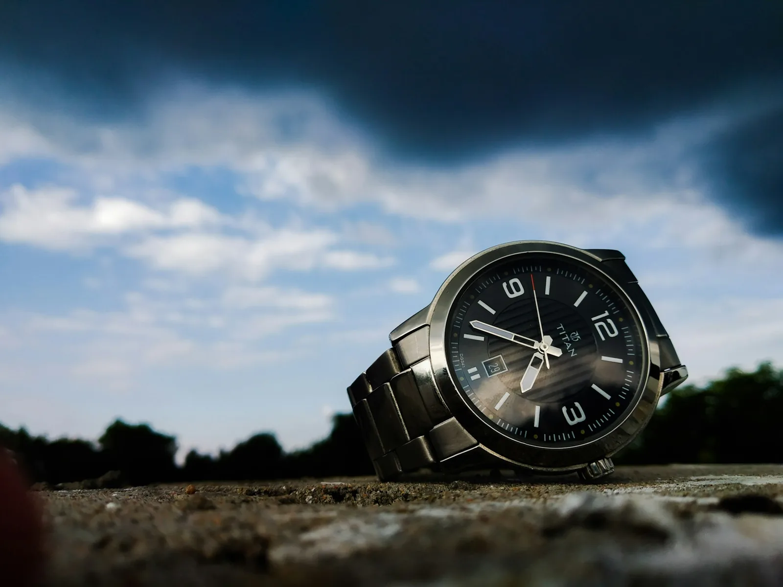 A watch dial photographed with the seconds hand blurred as it sweeps across the markers