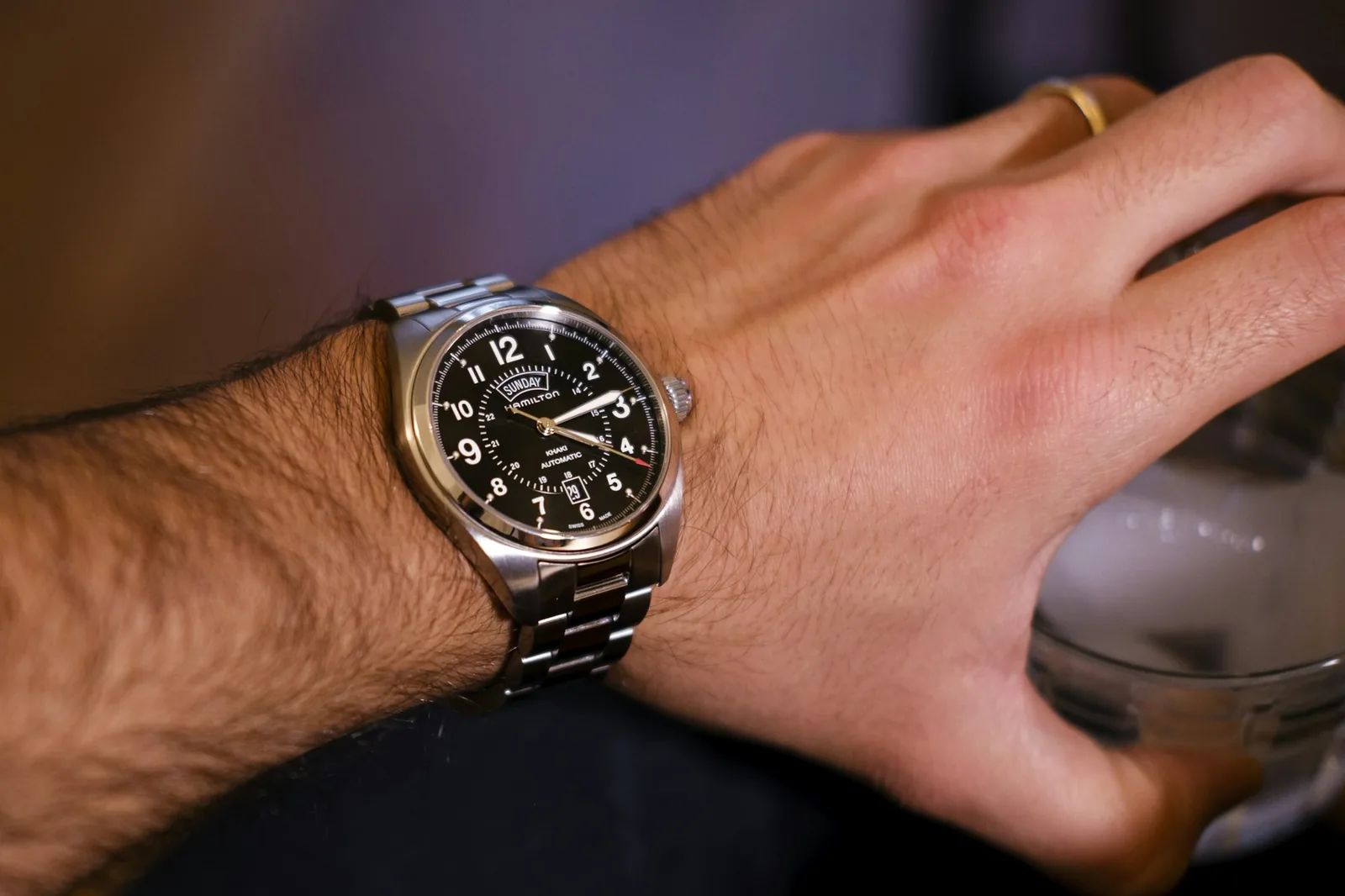 A wristwatch worn on a wrist, photographed close up from above