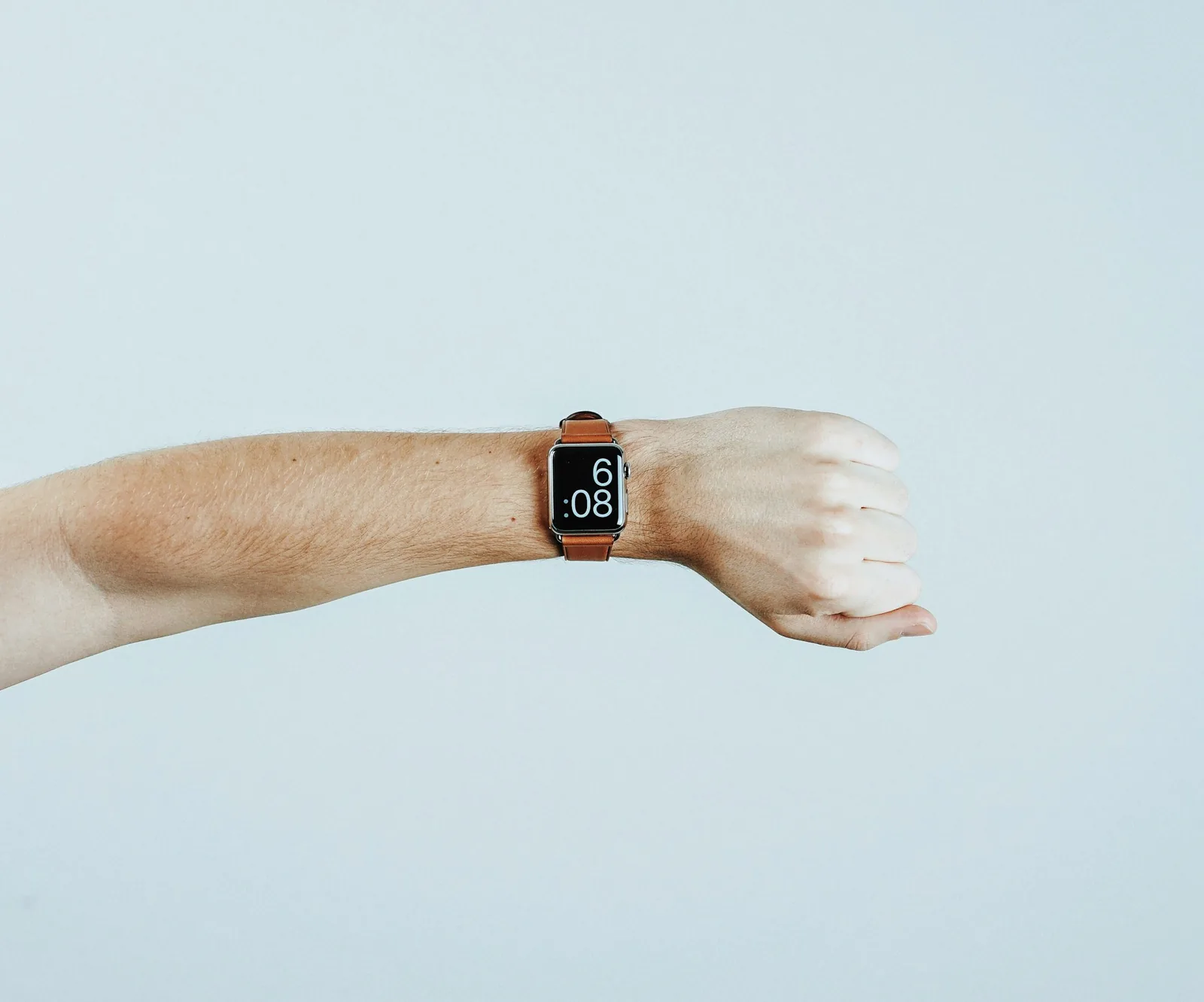 A wristwatch being photographed on a plain background under even light
