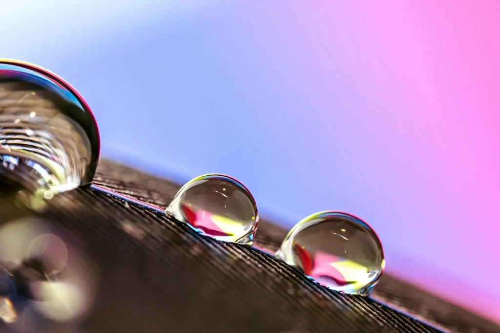 Beads of water sitting on the crystal and bezel of a wristwatch