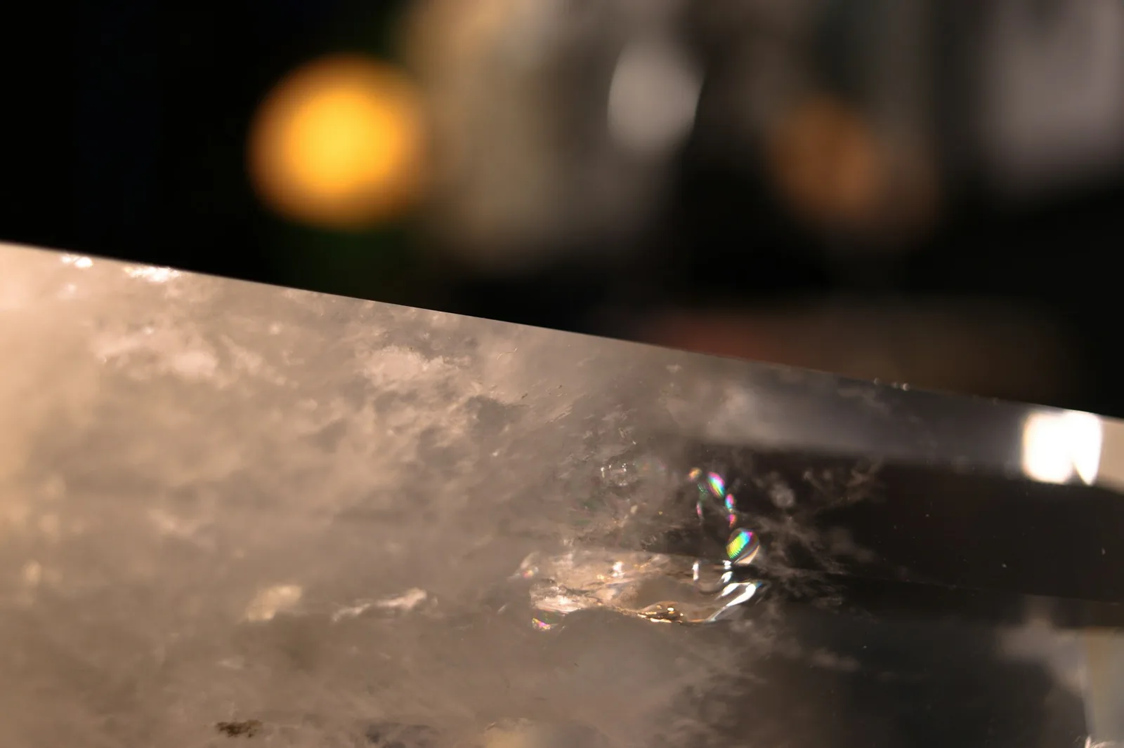 Beads of water sitting on the crystal and bezel of a wristwatch