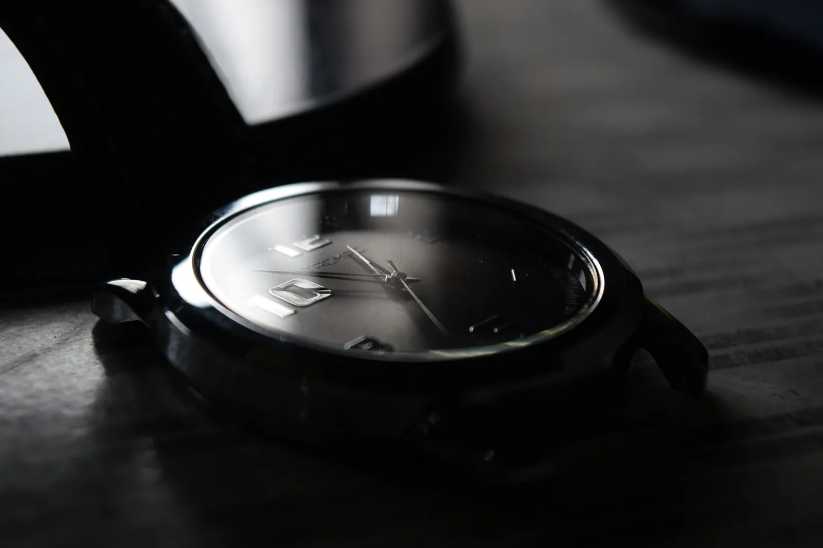 The side of a watch case showing a knurled screw-down crown and its guards