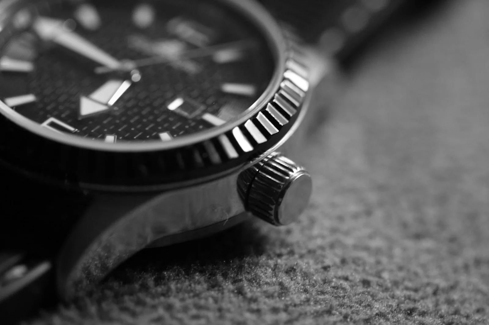 The textured surface of a black rubber watch strap photographed close up