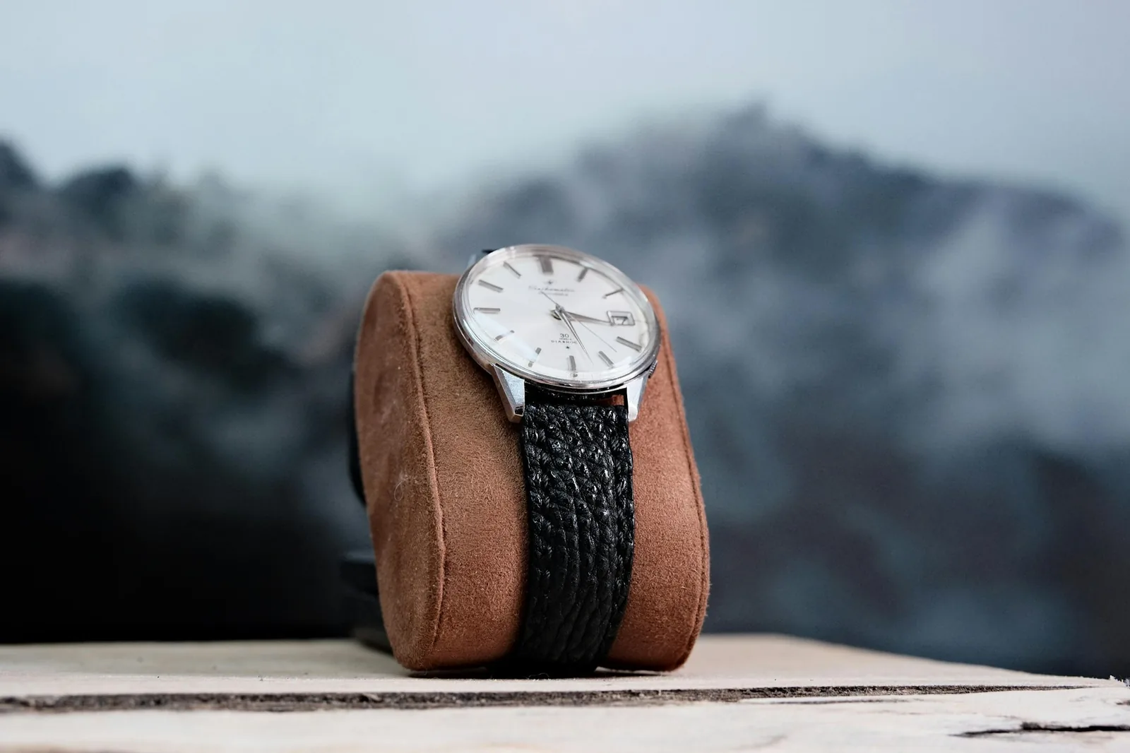 A small-dialled wristwatch on a leather strap photographed from above